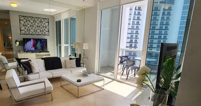 a living room with furniture a fireplace and a potted plant