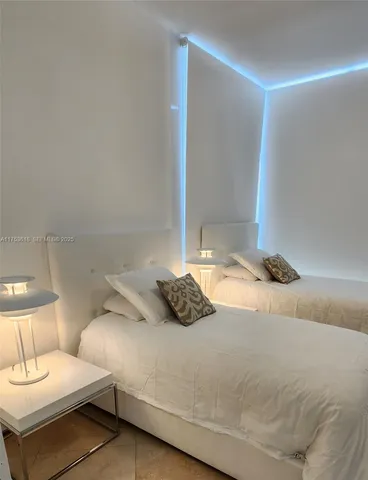 a bedroom with a bed and a night stand