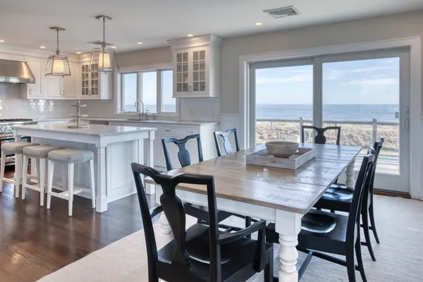 a view of a dining room and livingroom with lots of furniture wooden floor and a chandelier