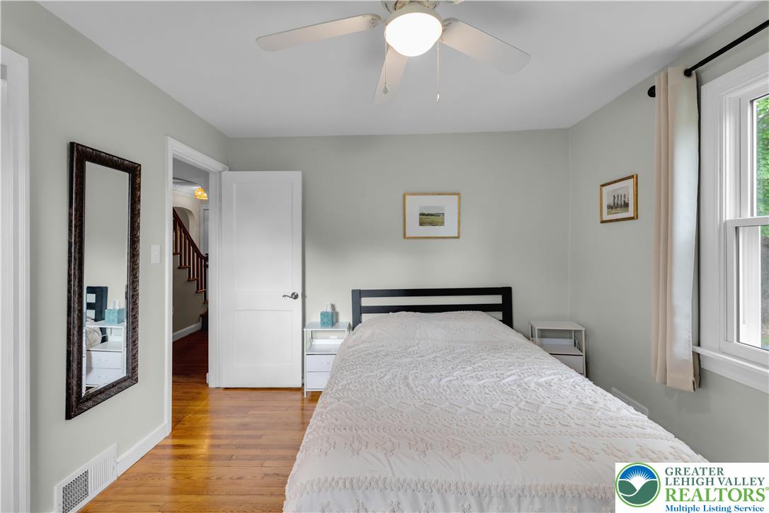 2242 Church Road Bethlehem, PA 18015 - Photo 48 of 74 a bedroom with a large bed and a chandelier