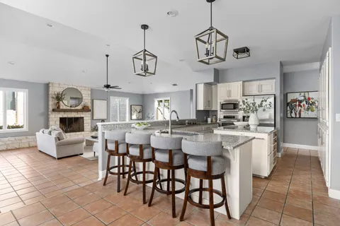 a dining room with furniture window and chandelier