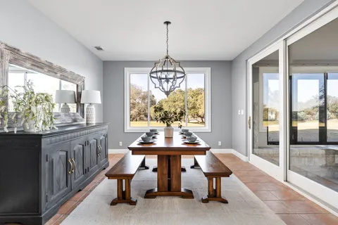 a bedroom with a bed and a large window with mirror