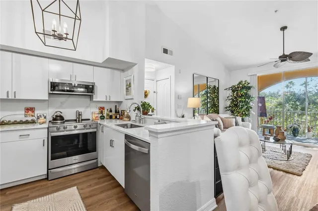 a kitchen with stainless steel appliances a refrigerator sink and cabinets