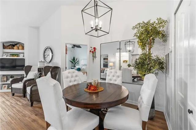 a kitchen with stainless steel appliances kitchen island granite countertop a table and chairs