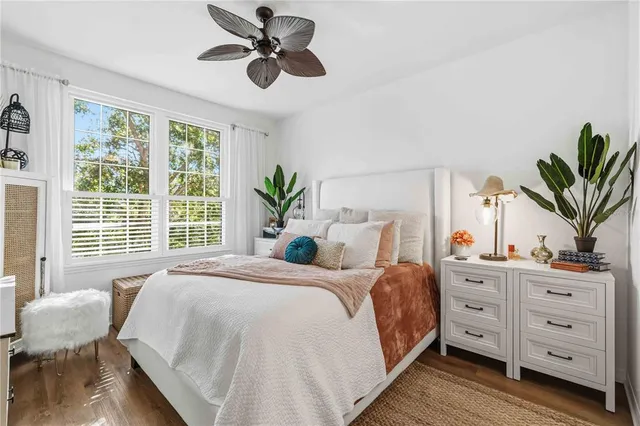 a bedroom with bed and windows