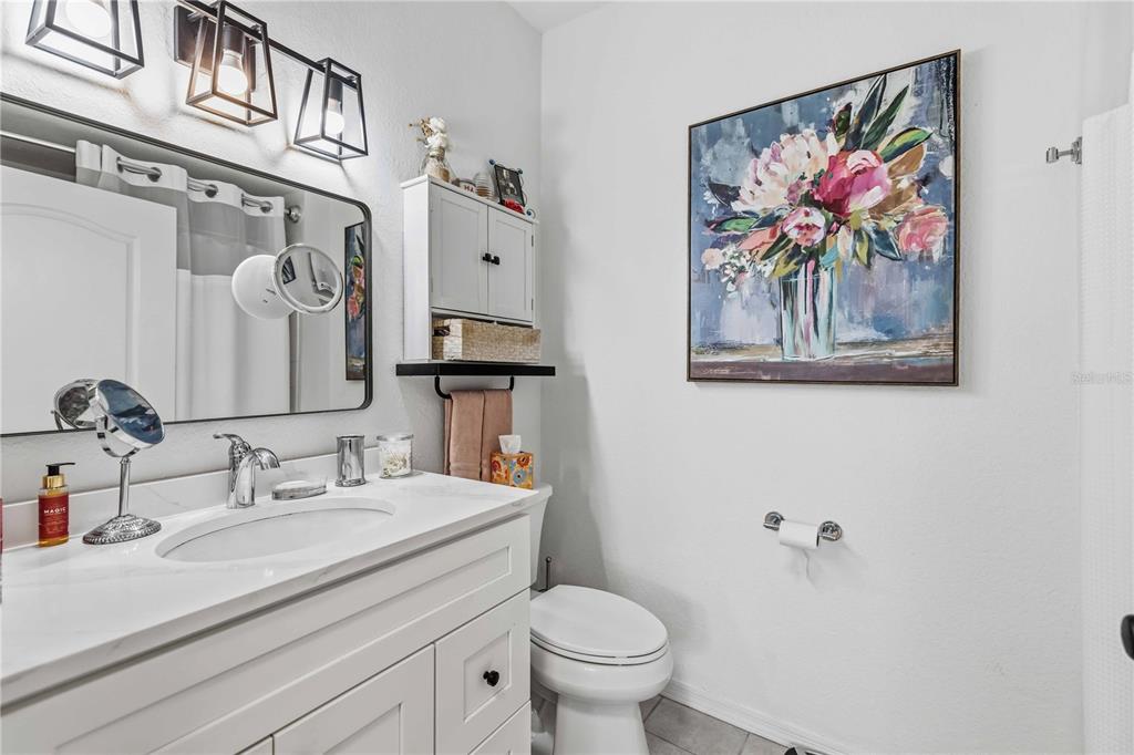4110 Central Sarasota Parkway, Unit 134 Sarasota, FL 34238 - Photo 23 of 32 a bathroom with a sink a toilet and a mirror