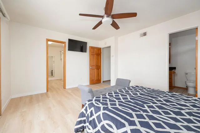 a bedroom with a bed and a chandelier