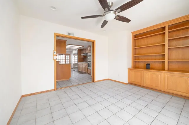 a view of an empty room with cabinet and a window