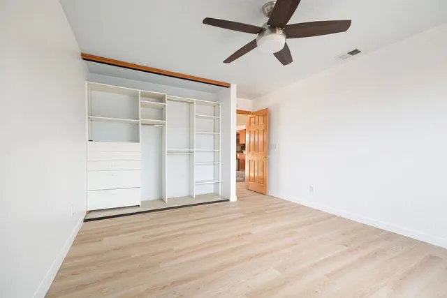 an empty room with a empty space and windows