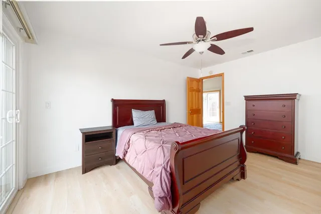 a bedroom with a bed and window
