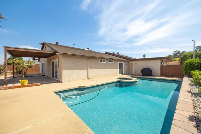 a view of a backyard with plants and a patio