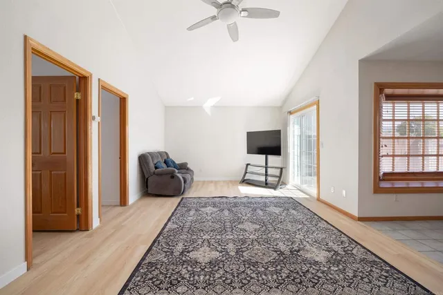 a living room with a bed furniture and a window