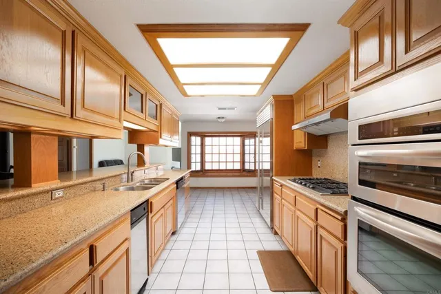 a kitchen with stainless steel appliances granite countertop a stove and a sink