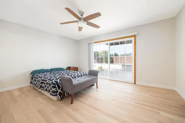 a spacious bedroom with a bed and a large window
