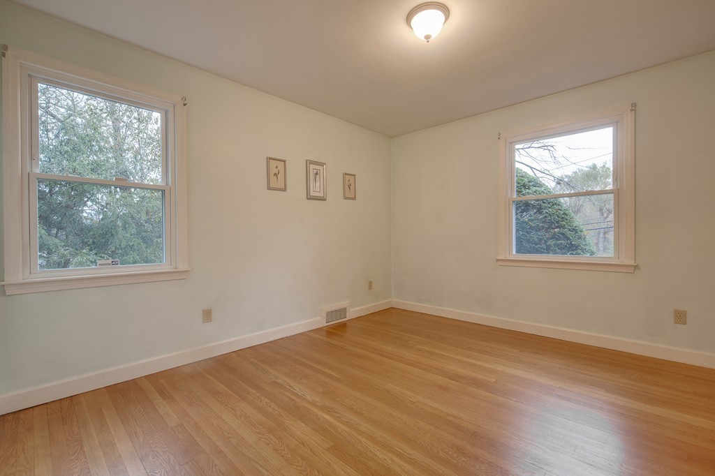 11 Douglas Road Chelmsford, MA 01824 - Photo 16 of 18 a view of an empty room with wooden floor and a window