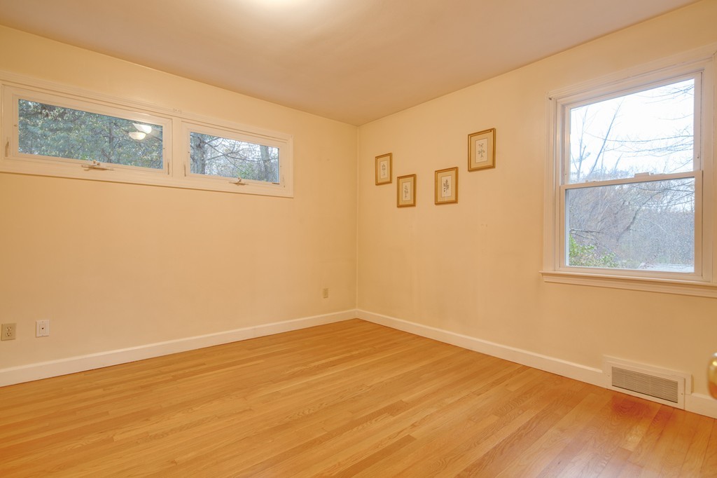 11 Douglas Road Chelmsford, MA 01824 - Photo 18 of 18 a view of an empty room with wooden floor and a window