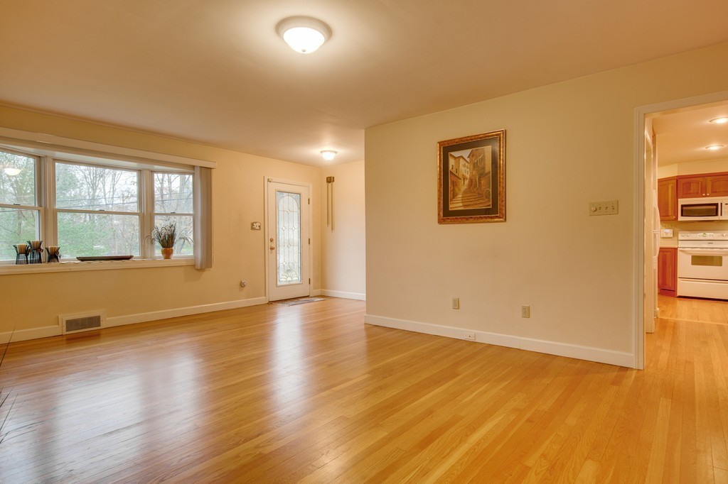 11 Douglas Road Chelmsford, MA 01824 - Photo 3 of 18 an empty room with wooden floor and windows