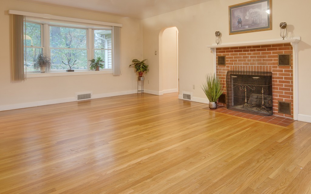 11 Douglas Road Chelmsford, MA 01824 - Photo 5 of 18 a view of empty room with wooden floor and fireplace