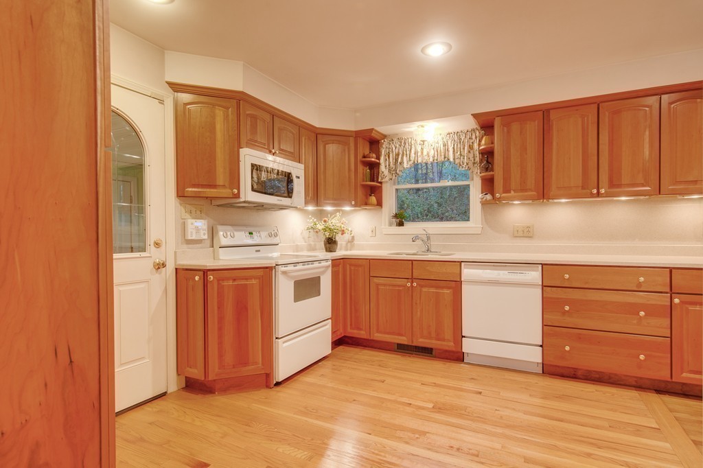 11 Douglas Road Chelmsford, MA 01824 - Photo 7 of 18 a kitchen with stainless steel appliances granite countertop a stove a sink and a microwave