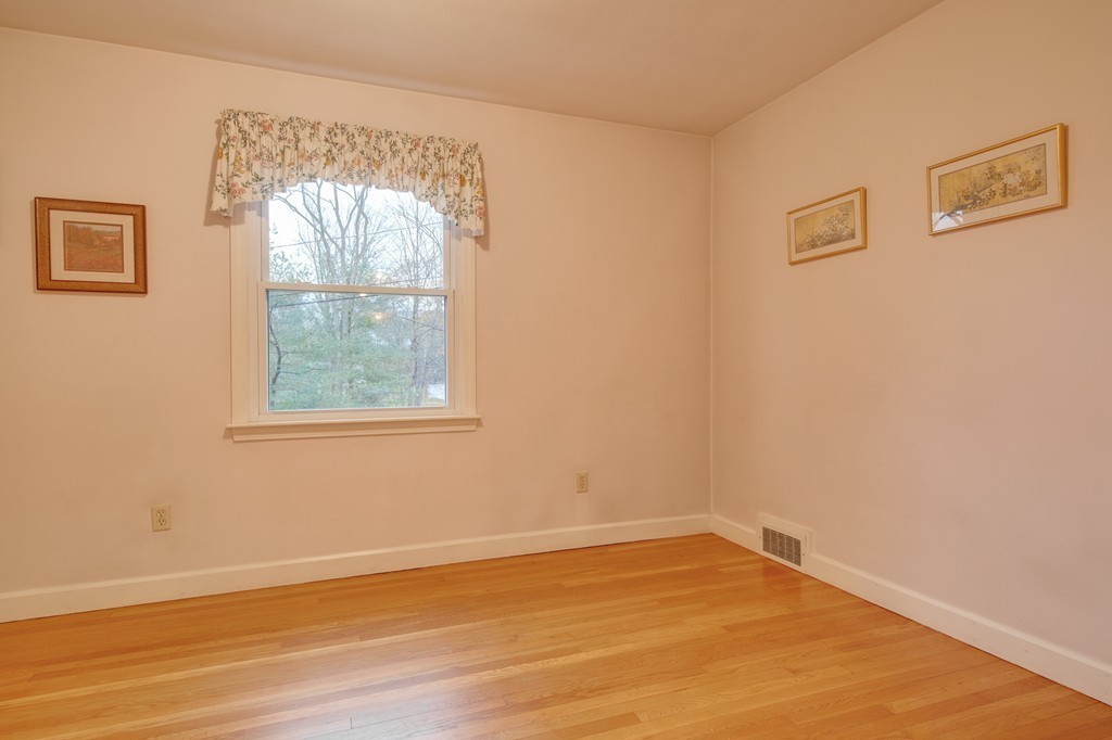11 Douglas Road Chelmsford, MA 01824 - Photo 9 of 18 an empty room with wooden floor and windows
