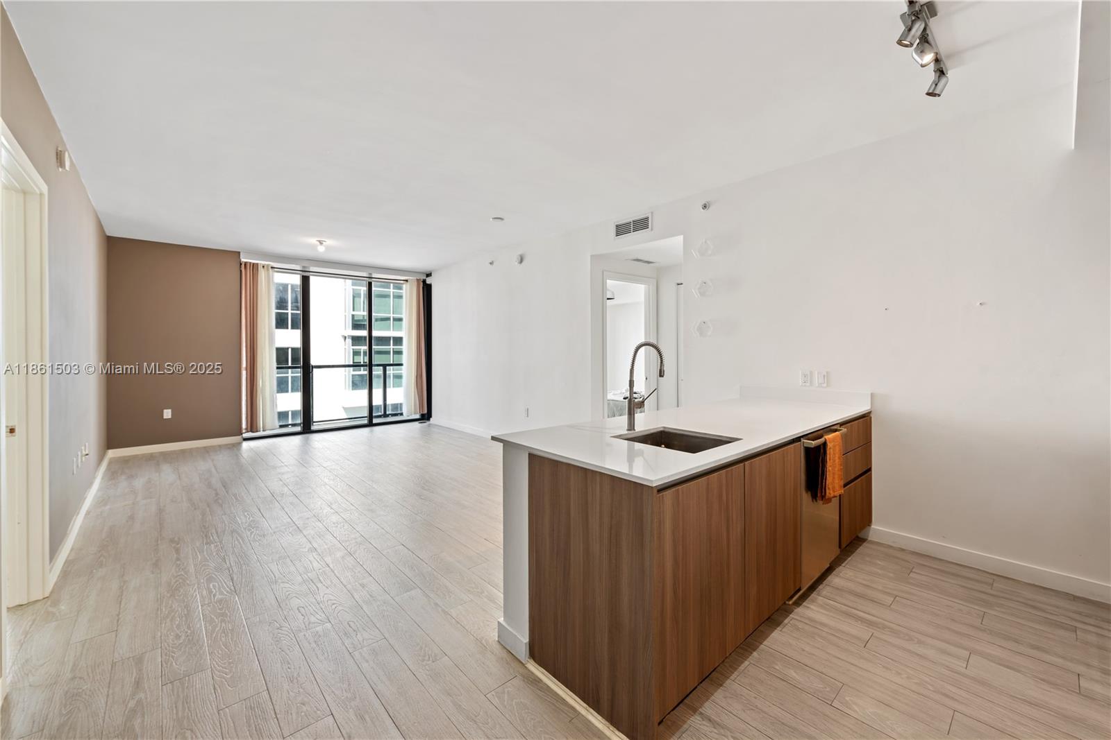 201 Southwest 17th Road, Unit 502 Miami, FL 33129 - Photo 1 of 17 a kitchen with stainless steel appliances a sink and wooden floor