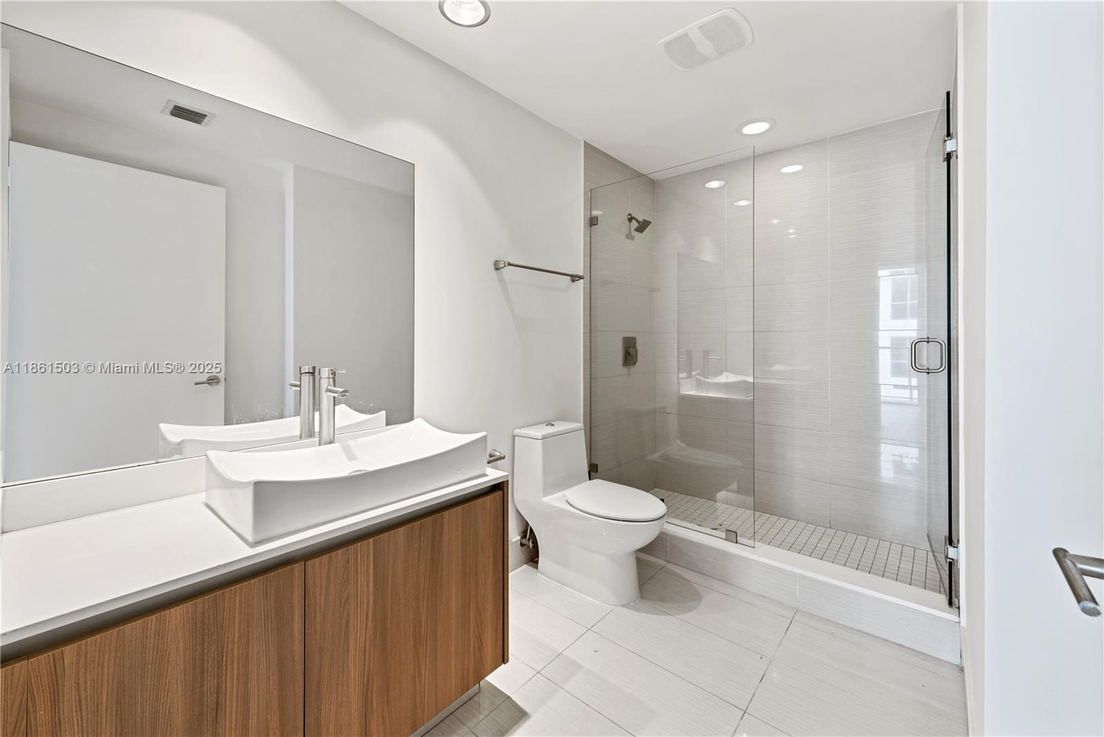 201 Southwest 17th Road, Unit 502 Miami, FL 33129 - Photo 16 of 17 a bathroom with a sink a toilet and shower