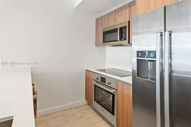 a kitchen with a refrigerator and a microwave