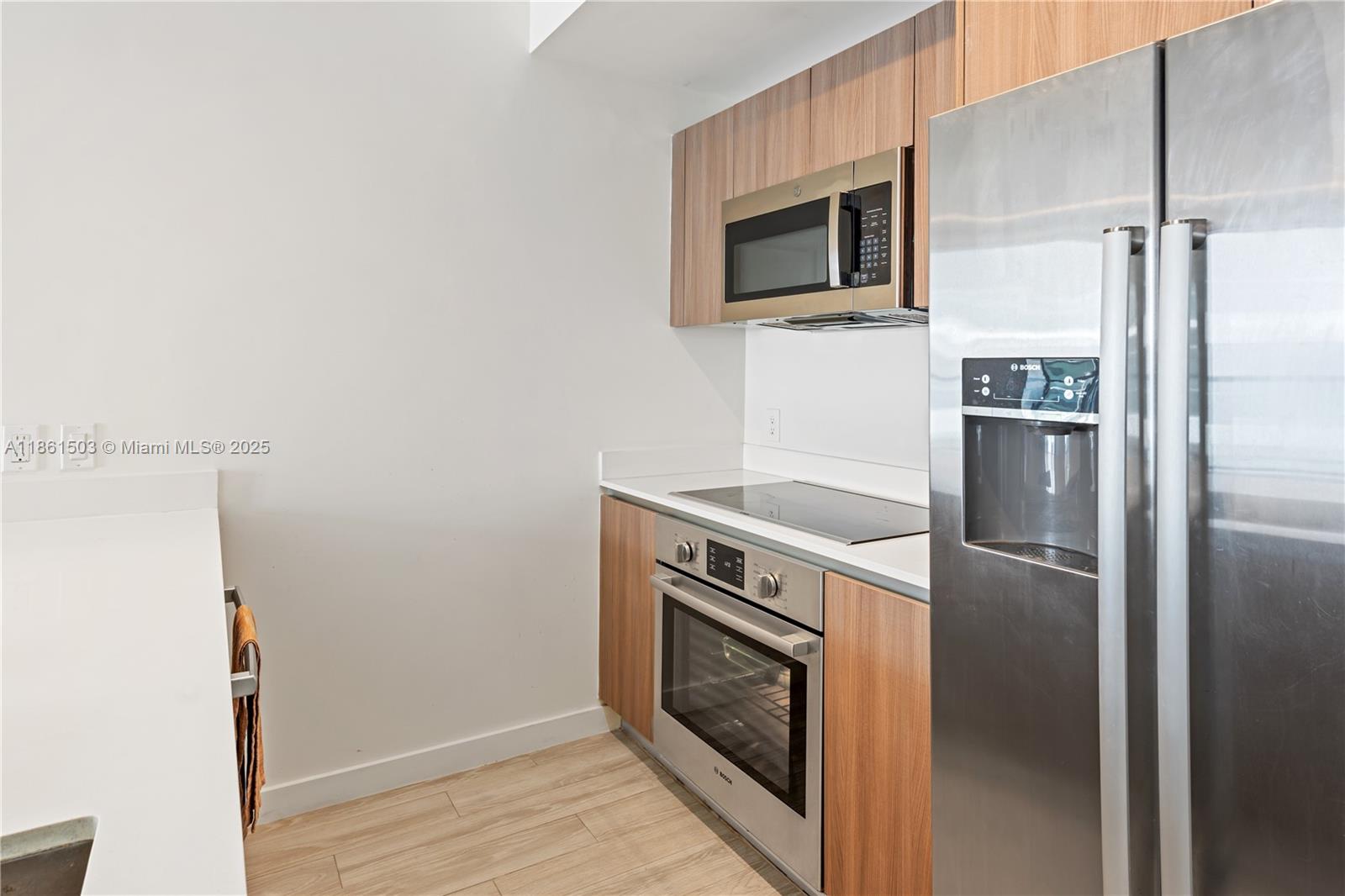 201 Southwest 17th Road, Unit 502 Miami, FL 33129 - Photo 6 of 17 a kitchen with a refrigerator and a microwave