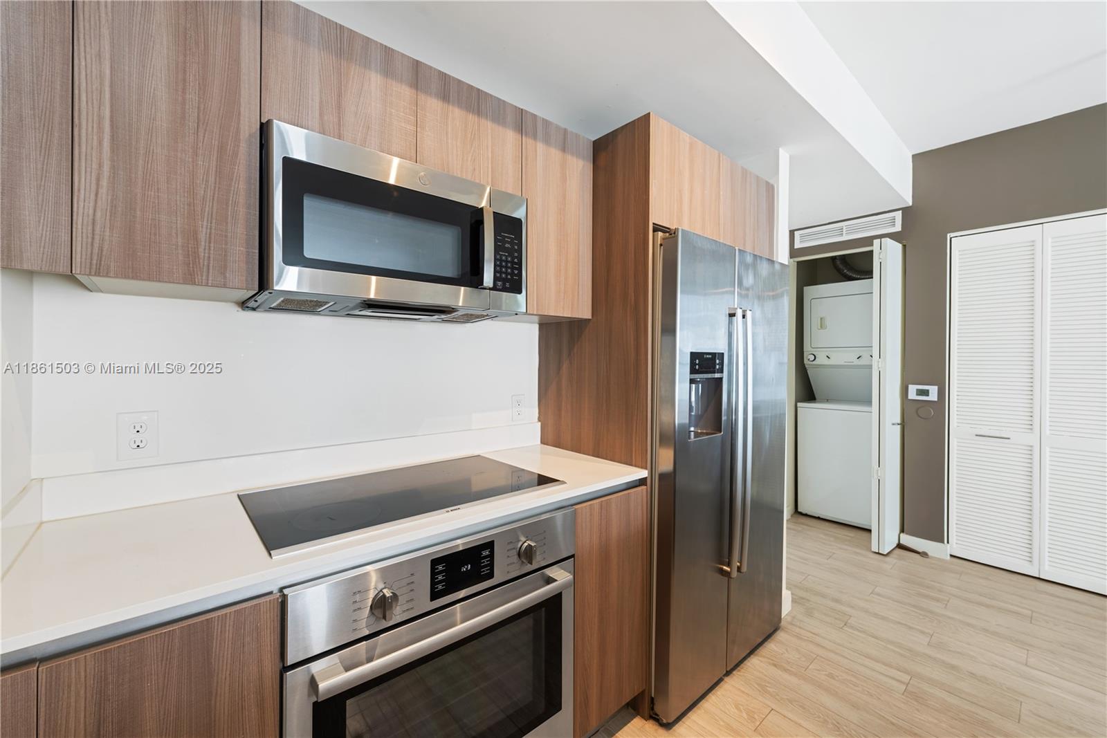 201 Southwest 17th Road, Unit 502 Miami, FL 33129 - Photo 7 of 17 a kitchen with a stove and a microwave