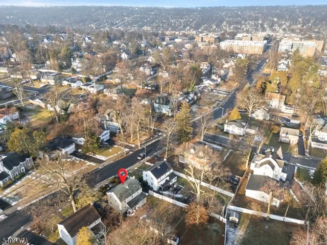 an aerial view of residential houses with city view