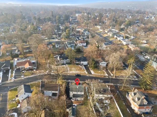 an aerial view of residential houses with city view