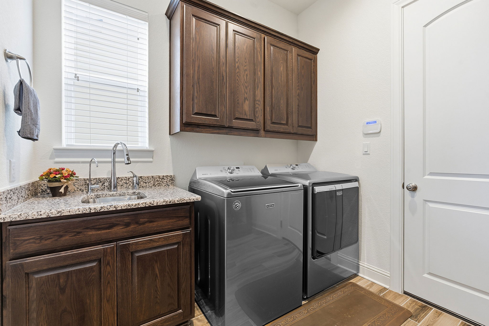 2824 Wedgescale Pass Leander, TX 78641 - Photo 36 of 40 Laundry room with built-in sink and cabinetry for added convenience