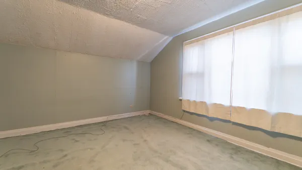 a view of an empty room and window
