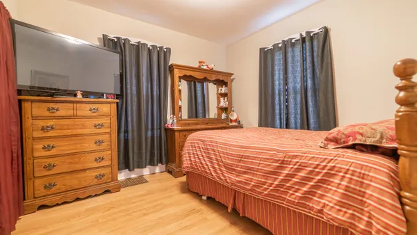 a bedroom with a bed and a mirror
