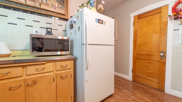 a white refrigerator freezer sitting inside of a kitchen
