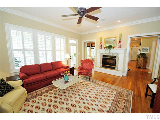 1336 Banbury Road Raleigh, NC 27607 - Photo 2 of 12 a living room with furniture a fireplace and a flat screen tv