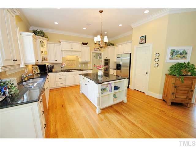 1336 Banbury Road Raleigh, NC 27607 - Photo 4 of 12 a large white kitchen with wooden floors