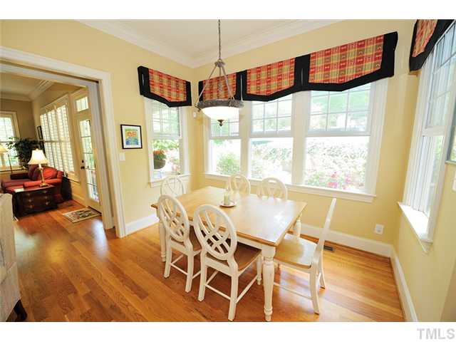 1336 Banbury Road Raleigh, NC 27607 - Photo 5 of 12 a view of a dining room with furniture wooden floor and a chandelier