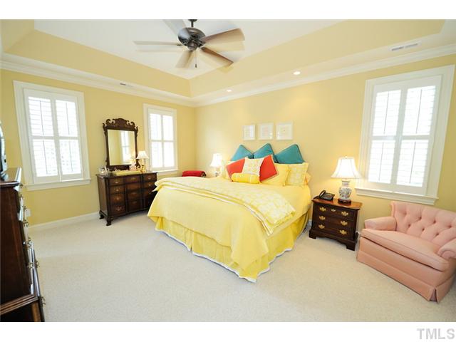 1336 Banbury Road Raleigh, NC 27607 - Photo 9 of 12 a bedroom with a large bed and wooden floor