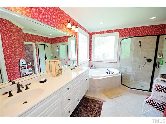 1336 Banbury Road Raleigh, NC 27607 - Photo 10 of 12 a bathroom with a sink mirror bathtub and toilet