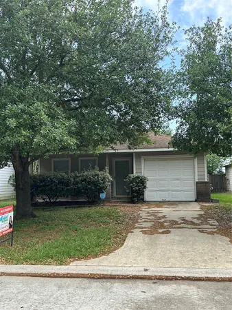 a front view of house with yard and trees