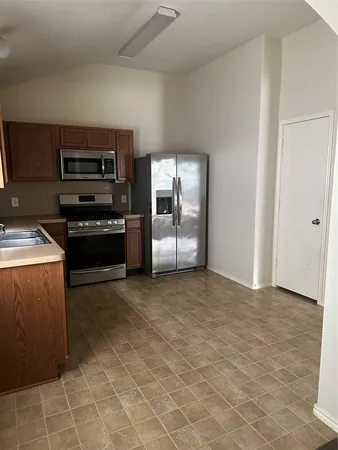 a kitchen with a stove and a refrigerator