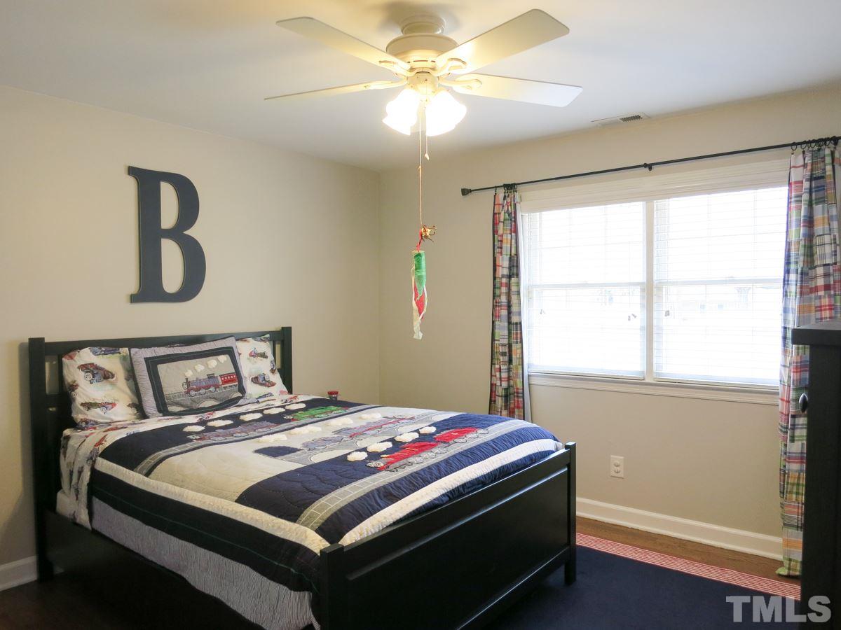 912 Hardimont Road Raleigh, NC 27609 - Photo 20 of 25 a bedroom with a bed and a window