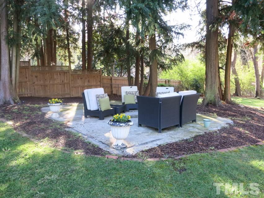 912 Hardimont Road Raleigh, NC 27609 - Photo 23 of 25 a view of a backyard with table and chairs and a fire pit