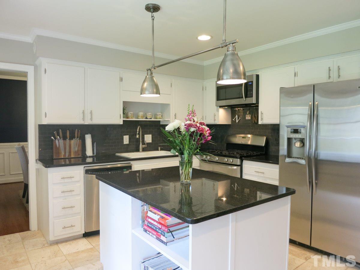 912 Hardimont Road Raleigh, NC 27609 - Photo 9 of 25 a kitchen with stainless steel appliances granite countertop a sink a stove and a refrigerator