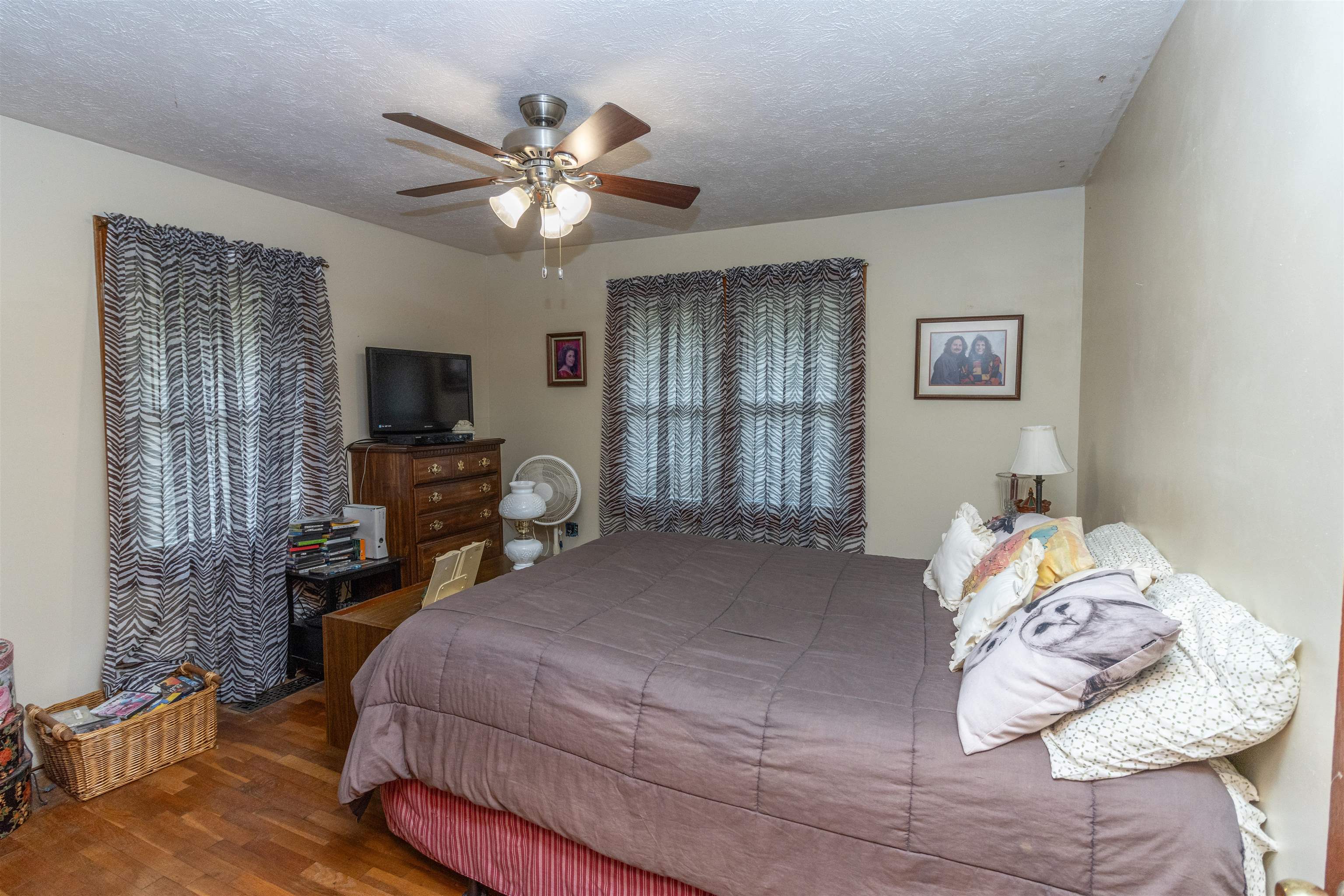 33 Skyline Road Selmer, TN 38375 - Photo 11 of 19 Bedroom with a textured ceiling, hardwood / wood-style flooring, and ceiling fan