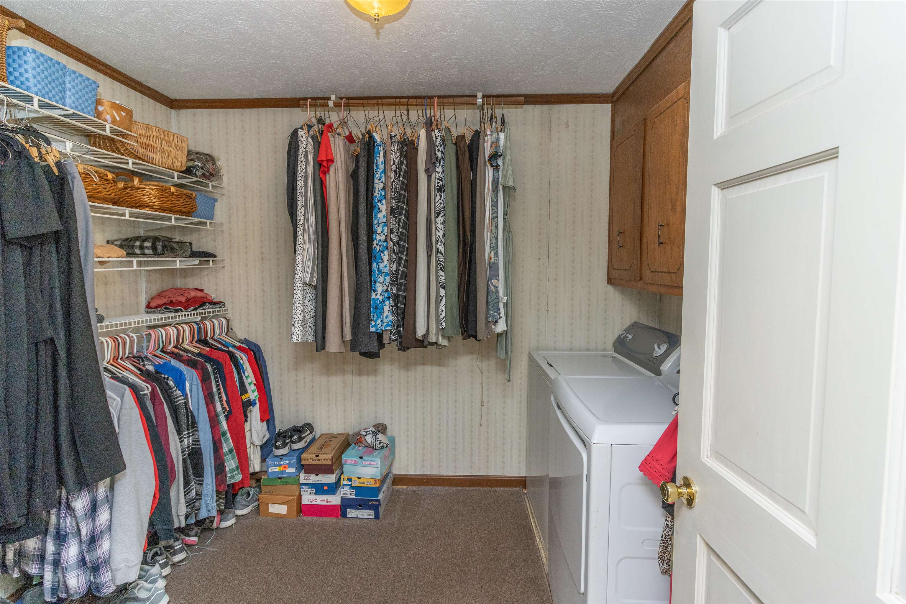 33 Skyline Road Selmer, TN 38375 - Photo 17 of 19 Clothes washing area featuring carpet, a textured ceiling, washing machine and dryer, and ornamental molding