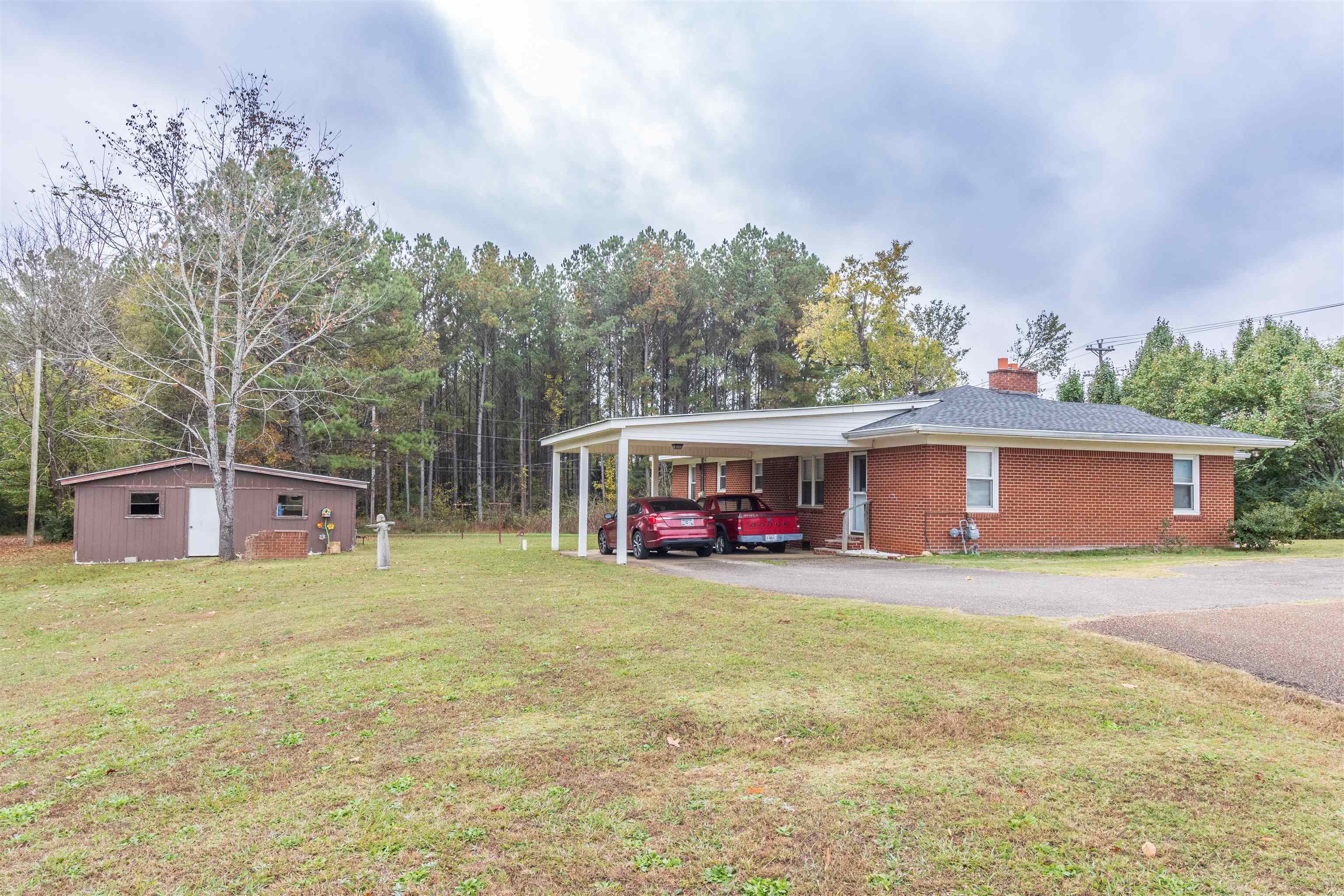 33 Skyline Road Selmer, TN 38375 - Photo 4 of 19 View of front of home with an outdoor structure, a front lawn, and a carport