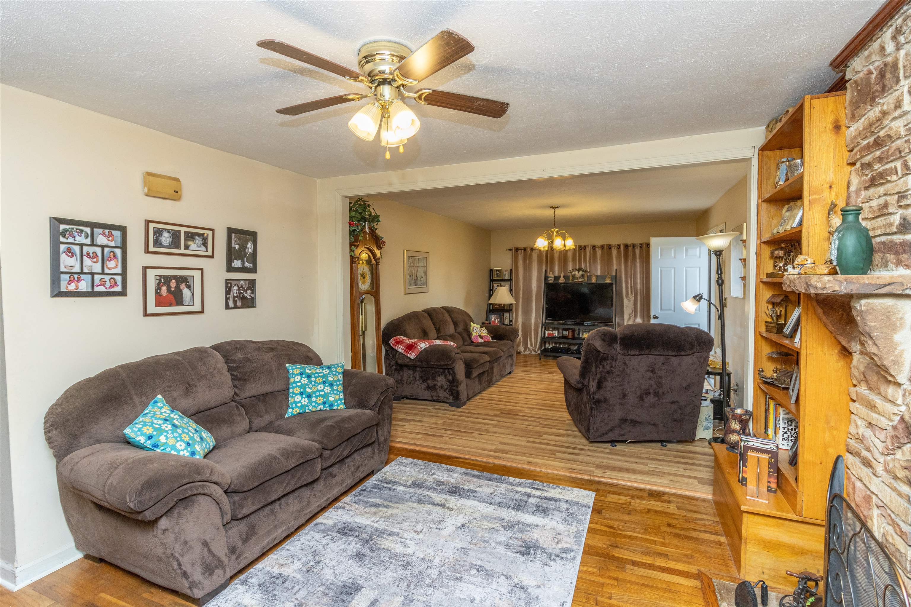33 Skyline Road Selmer, TN 38375 - Photo 7 of 19 Living room featuring light hardwood / wood-style flooring, a textured ceiling, and ceiling fan with notable chandelier