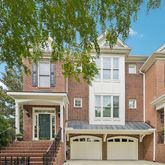 a front view of a house with a tree